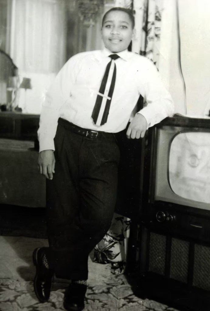 Emmett pictured by tv set at home in Chicago